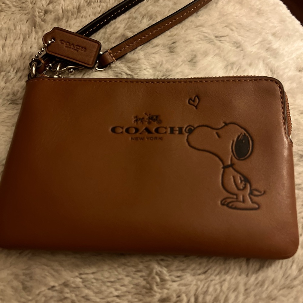 Coach Peanuts Collection wristlet with Snoopy “kiss”